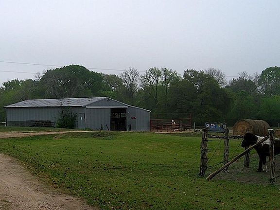 Horse barn with 4 stalls, with turn outs, tack room and hay/feed storage section on slab