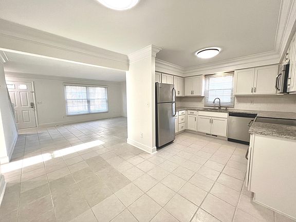 Kitchen, dining, and living room areas.