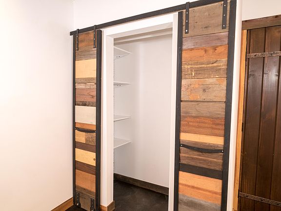 Custom wrought iron and mixed wood sliding closet doors