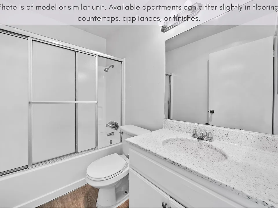 Clean bathroom featuring a full tub and functional vanity space.