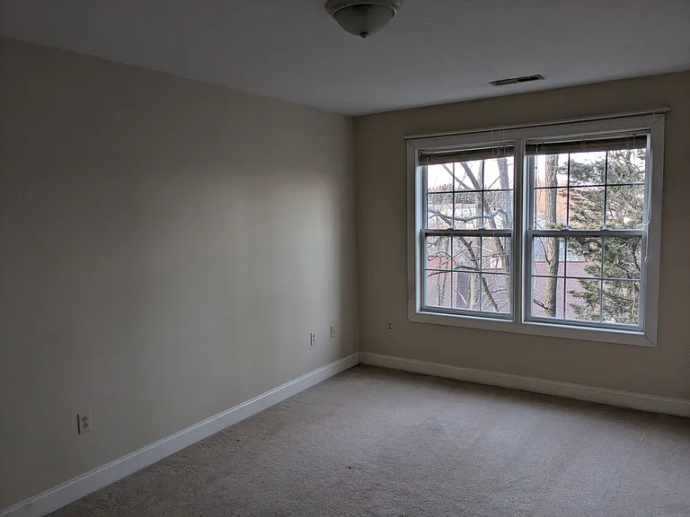 View of the room's front wall facing toward the left wall.