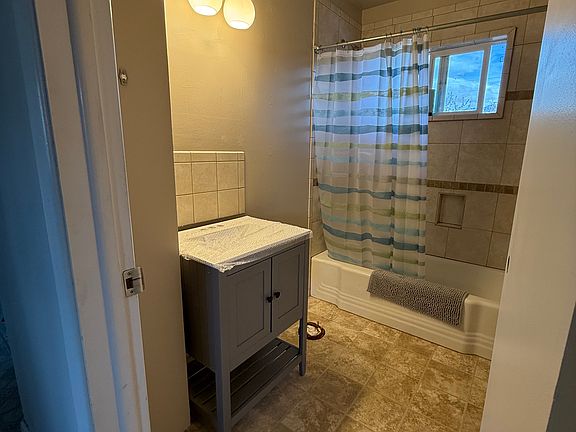 During renovations - fresh paint, new vanity/mirror and light fixture in the bathroom