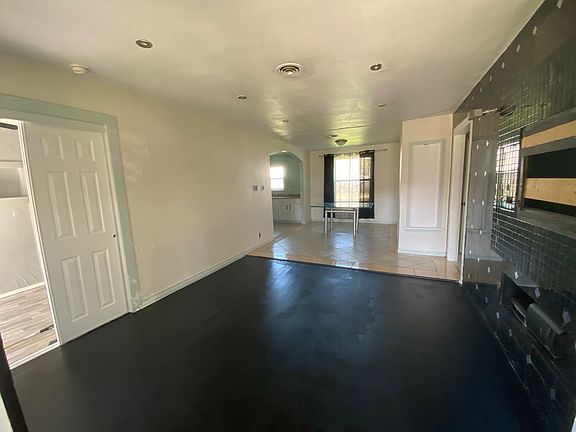 View of living room into dining room. Door on L side of picture is third bedroom entrance.