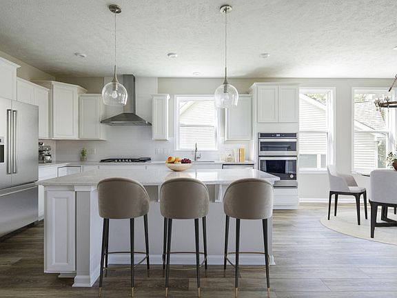 Gourmet Kitchen with White Cabinets and Pendant Lighting
