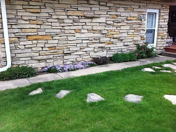 Small fenced in rear yd : Fenced in rear yard off of patio - beautiful exterior stonework.