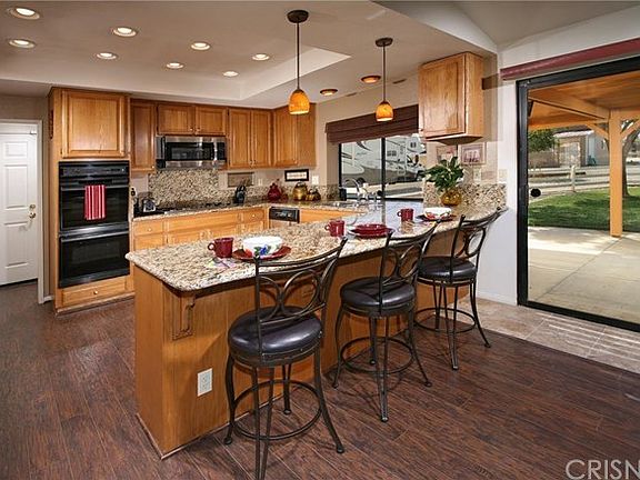 The familys chef is going to truly appreciate the remodeled gourmet kitchens trey ceiling with inset canned lighting, abundant cabinets that reach the ceiling, durable dual basin stainless steel sink, granite countertops with full backsplash, stainless st