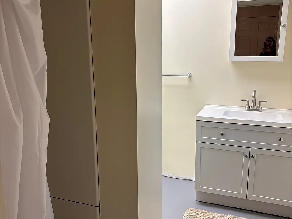 Bathroom with stand-up shower stall and new vanity