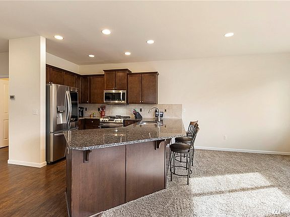 Kitchen bar seating for entertaining.  Upgraded Stainless Steel LG kitchen appliance suite included!  Knock on the fridge glass to see inside.