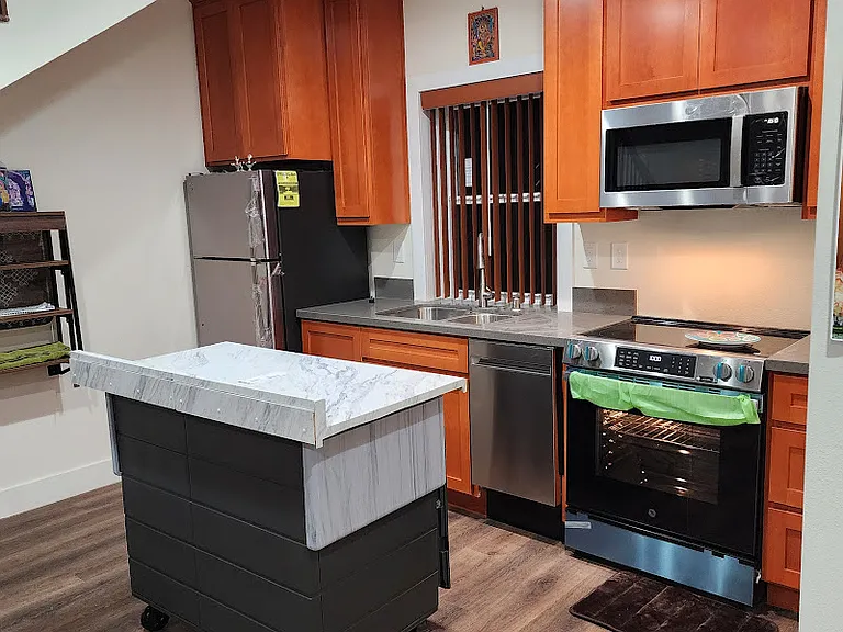 'Kitchen Island' on-wheels with locks gives flexibility of it's location when needed. It can be moved & tucked under the staircase, when not in use to make space for living room.