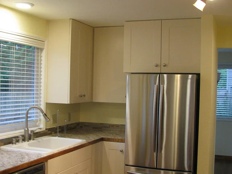 Bright kitchen with updated lighting, faucet and appliances