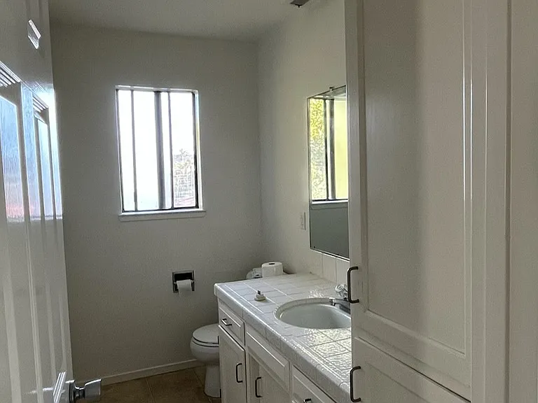 Upstairs half bathroom with cabinets