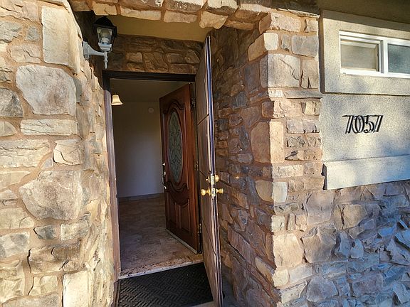 Exterior front entry with security screen door.