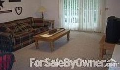 Living room : Pull out sofa, tv, end tables. closet for storage. doors to deck.