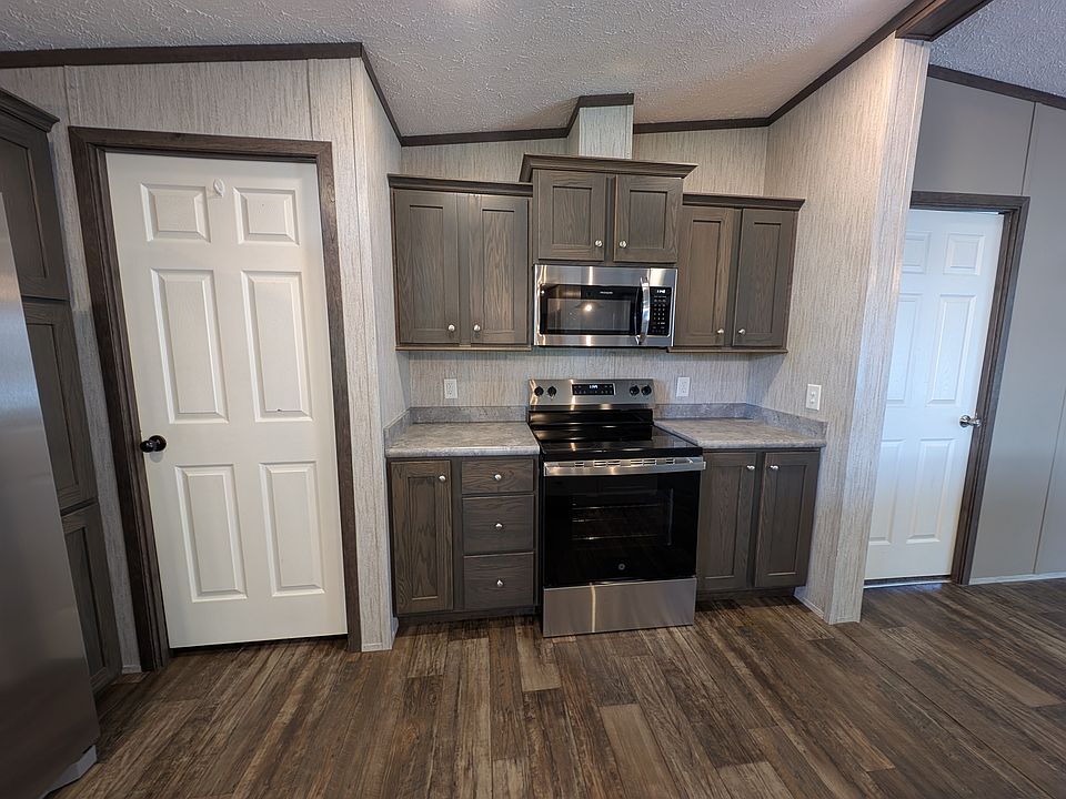 Electric Stove and Microwave with vent to outside. Door to left is walk in Pantry.