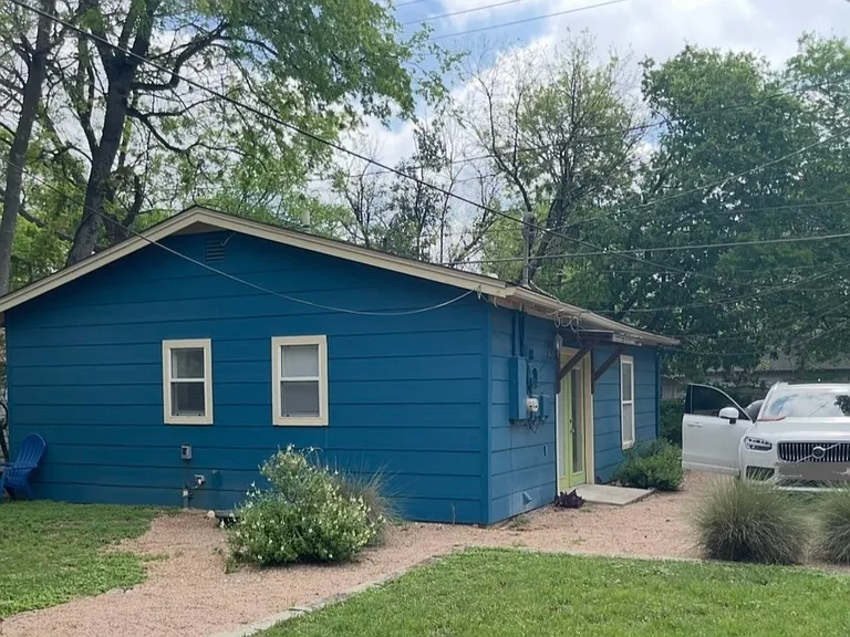 View of house, yard and parking space from front house. Alley is behind the house.
