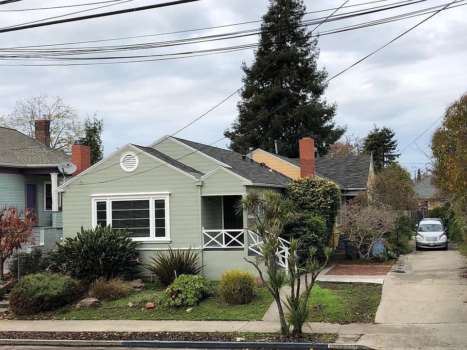Off-street parking is on the brick pad to right of house.