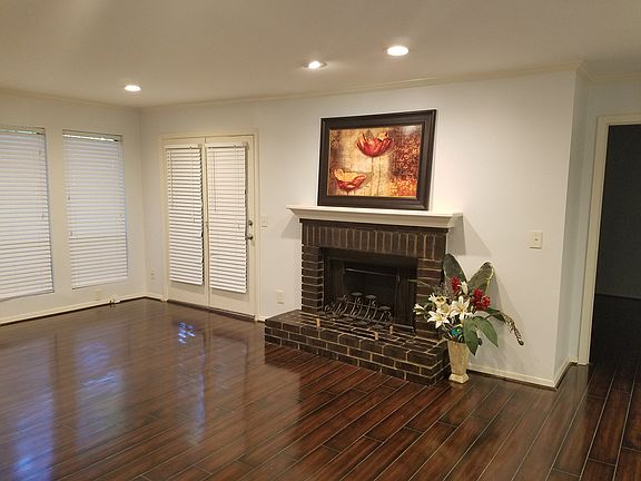 Living room with fireplace and door to deck from hallway