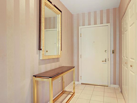 A welcoming foyer with a guest closet opens to the large living room