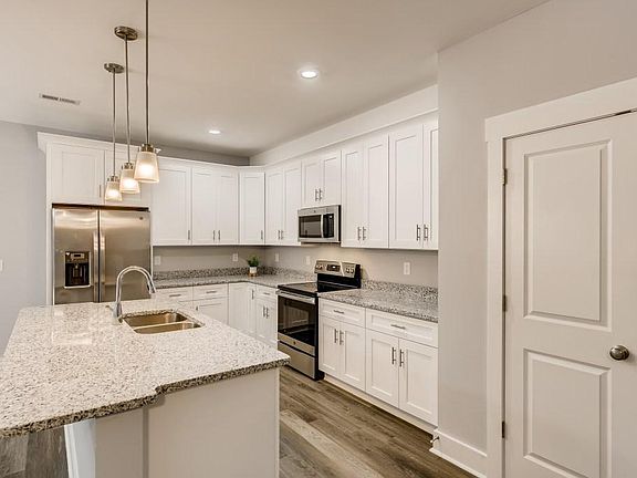 Enjoy lots of cabinet space, nice pendant and recessed lighting and a pantry closet in the kitchen.