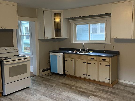 Kitchen, view 1; view from entryway door, plenty of cabinet space, new stove, dishwasher and flooring, fresh coat of paint.