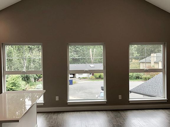 Living Room with three 6ft x 4ft large windows and 16 foot ceiling