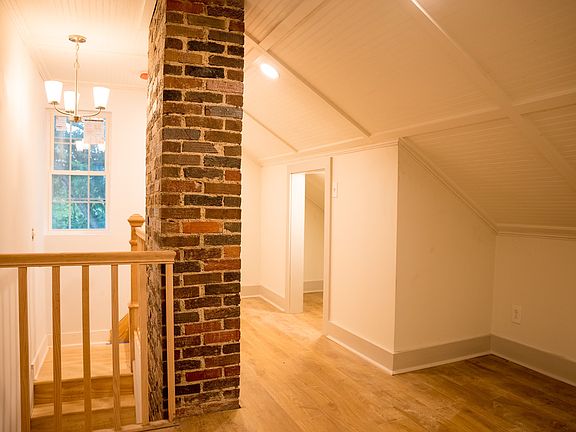 Upstairs hallway. Little nook (with outlet) and lit closet with door.