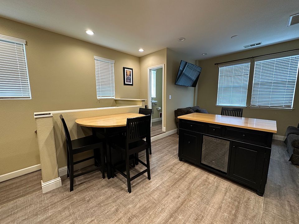 dining area and moveable island with wine fridge
