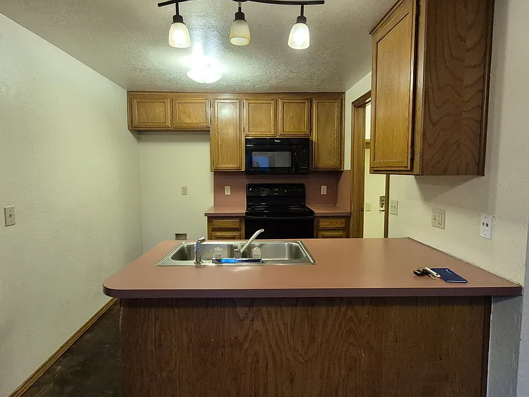 Kitchen with dishwasher, range, microwave