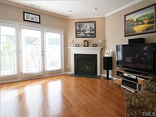 Cozy gas-log fireplace has slate surround and detailed mantel.