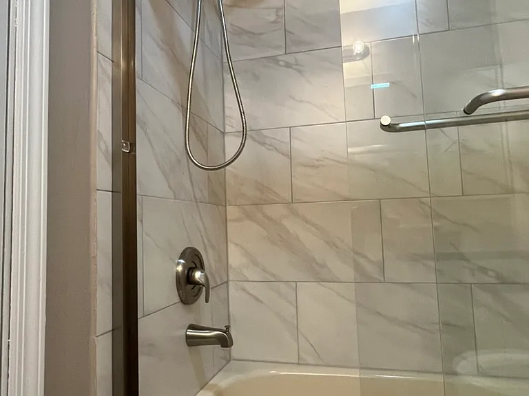 Upgraded Bathroom: 
Modern tile
Glass enclosure
Brushed nickel fixtures