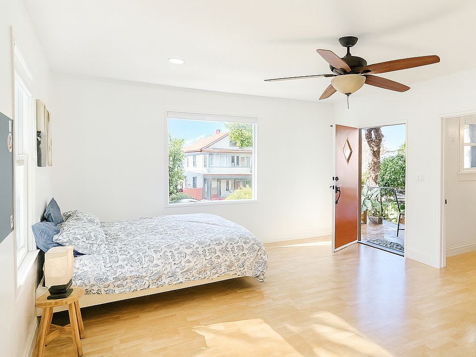 Bright, spacious main room with large windows and hardwood floors.