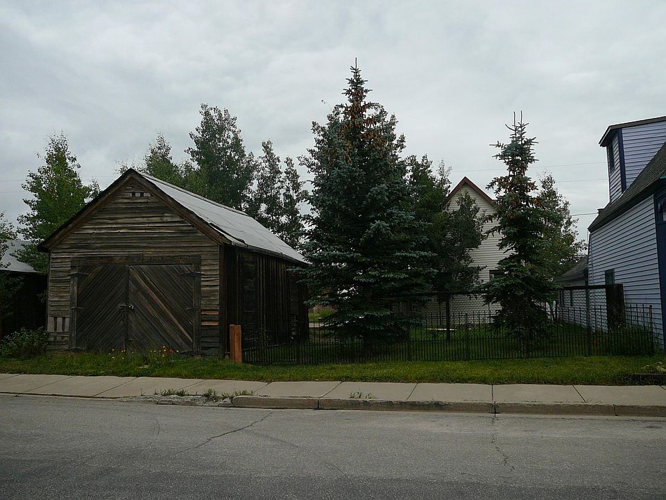 Street view on 4th Street, double lots, garage on left and h