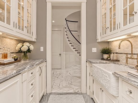 Butler's pantry with custom cabinetry, ample storage, and seamless support for everyday entertaining.