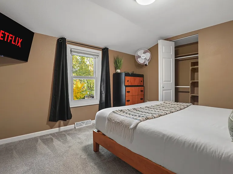 Queen bed, closet, fan, 40" smart TV, dresser.
