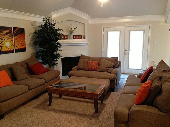 Large living room with high ceilings and a fireplace