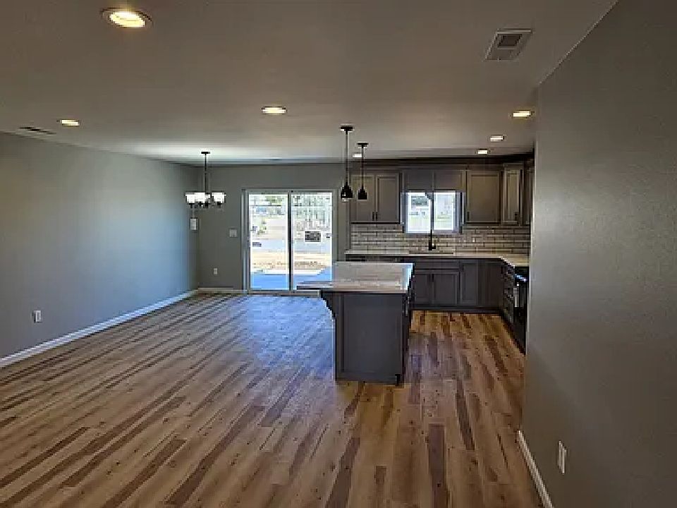 View looking out back from a similar unit. This one has different flooring, but show the space well.