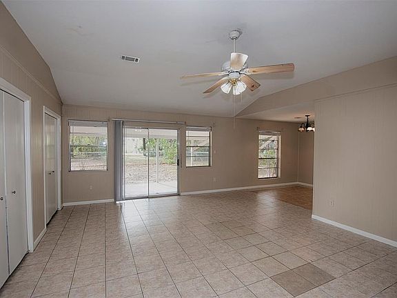 This is the view from the entry to the home of a wonderfully spacious family room with sliding doors to the covered patio and grounds.
