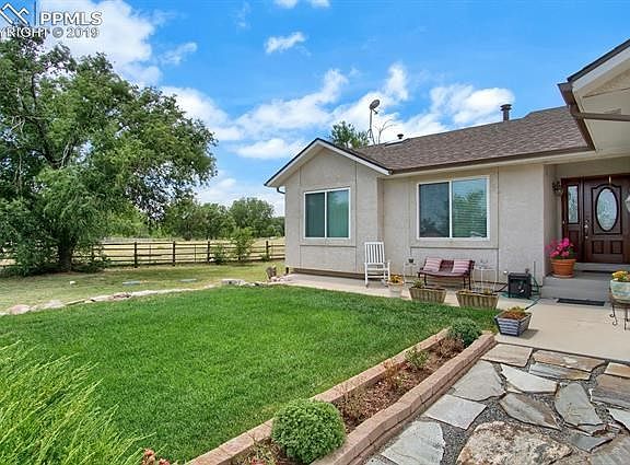 Thoughtful landscaping in front of home with concrete porch area