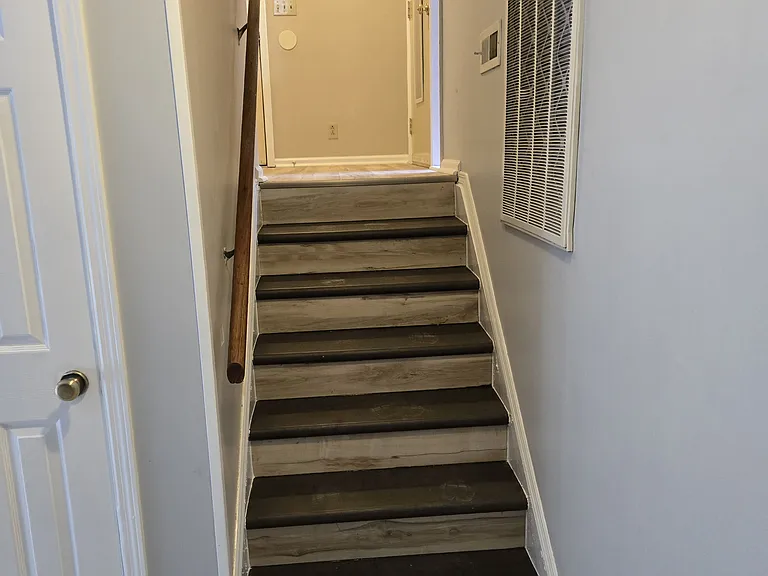 stairs going up from den to entry foyer