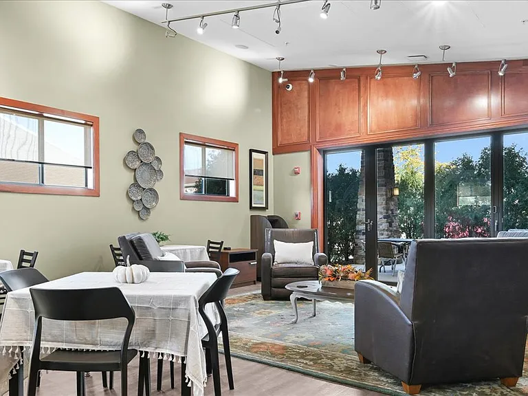Community gathering room with games, cozy seating, and large dining table for a variety of engageing events.