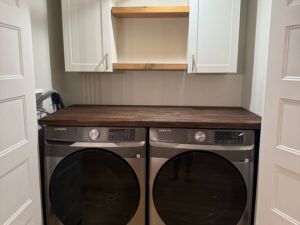 Washer and dryer with additional storage and folding area.