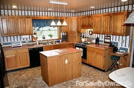 great kitchen with loads of cupboards : cupboards & counters galore incl island near sink, fridge, s