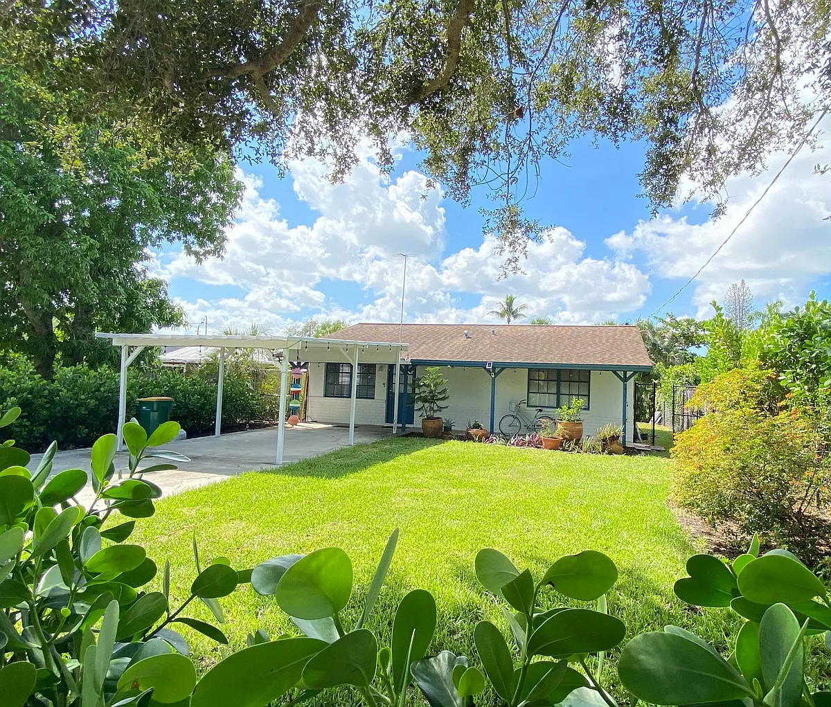 Front yard with carport and long drive way that is enclosed by rolling fence. Property is fully fenced along entire perimeter. - 1248 Highlands Dr
