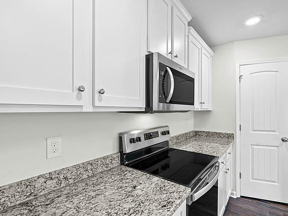White cabinetry and granite counters
