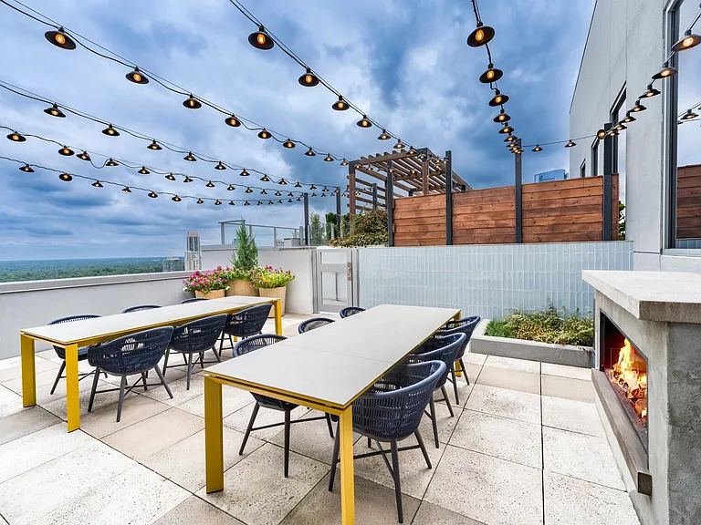 Rooftop evenings at Modera Old Ivy bring Atlanta skyline views, warm firelight, and inviting outdoor dining_just minutes from Buckhead's energy.