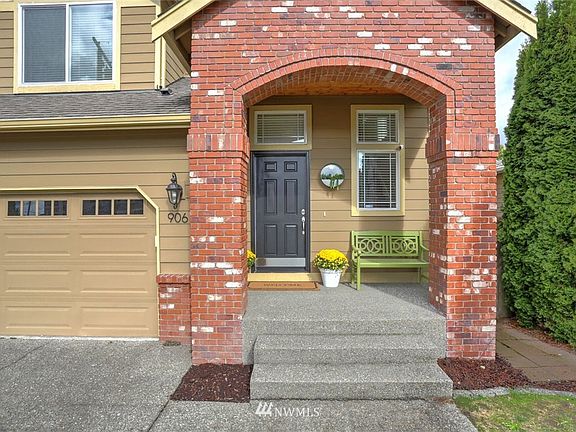 Elegant brick archway adds to the visually appealing architecture of this house.