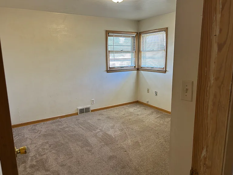Bedroom 1 with corner windows