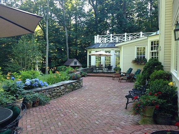 large patio perfect for summer entertaining; children will love the playhouse cabin