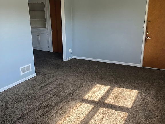Living room showing entrance door and dining room.