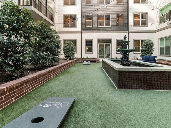 Main courtyard features a boutique, infinity-edge swimming pool and outdoor fire place